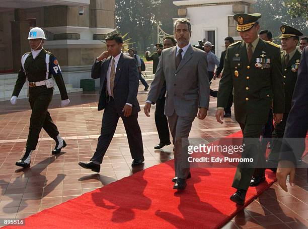 East Timorese President Xanana Gusmao walks with Indonesian Army officers after attending flower wreath ceremony during his second day visit in...