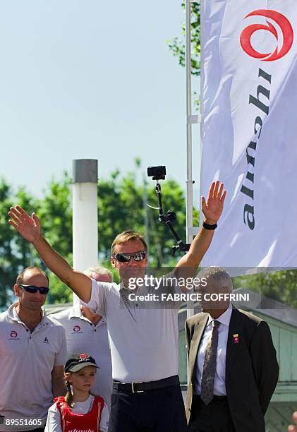 Owner of America's Cup defender syndicate Alinghi, Ernesto Bertarelli waves prior to the parade of the new giant high tech catamaran "Alinghi 5" at...