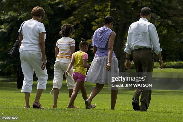 President Barack Obama walks with First Lady Michelle Obama , his daughters Sasha and Malia and his mother-in-law Marian Robinson as they walk the...