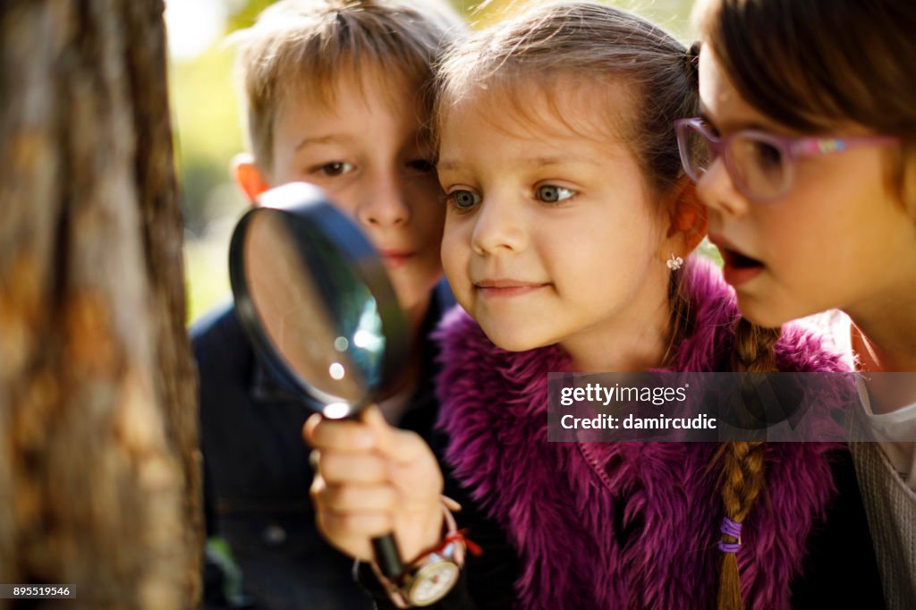 Kids with magnifying glass