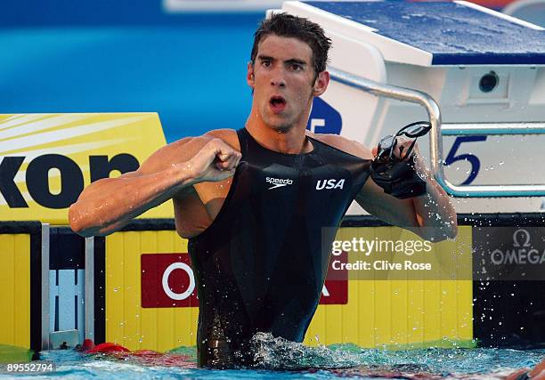 Michael Phelps of the United States celebrates victory in the Men's 100m Butterfly Final during the 13th FINA World Championships at the Stadio del...