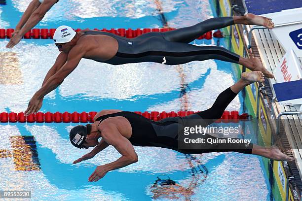 Milorad Cavic of Serbia and Michael Phelps of the United States compete in the Men's 100m Butterfly Final during the 13th FINA World Championships at...