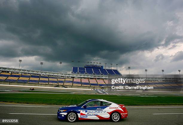 Safety Car drives through pitlane as storm clouds gather over the frontstretch grandstand during the IRL IndyCar Series Meijer Indy 300 on August 1,...