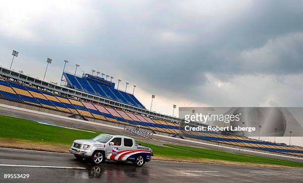 An IndyCar safety car drives by in pit lane after a rain shower during a delay in practice for the IRL IndyCar Series Meijer Indy 300 on August 1,...