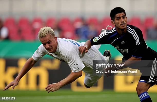 Carlos Zambrano of Schalke and Sebastian Schoof of Windeck compete for the ball during the DFB Cup first round match between TSV Germania Windeck and...