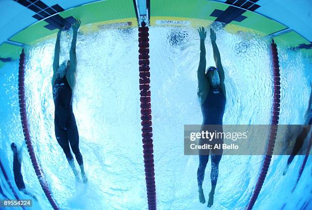 Michael Phelps of the United States finishes just in front of Milorad Cavic of Serbia to win the gold medal and break a new world record in a time of...