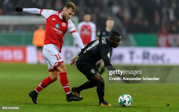 Alexandru Maxim of Mainz challenges Chadrac Akolo of Stuttgart during the DFB Cup match between 1. FSV Mainz 05 and VfB Stuttgart at Opel Arena on...