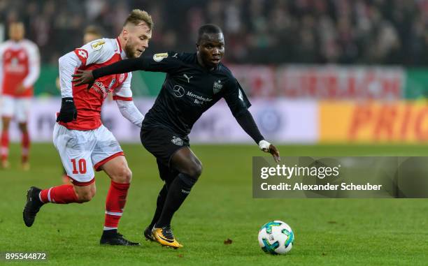 Alexandru Maxim of Mainz challenges Chadrac Akolo of Stuttgart during the DFB Cup match between 1. FSV Mainz 05 and VfB Stuttgart at Opel Arena on...