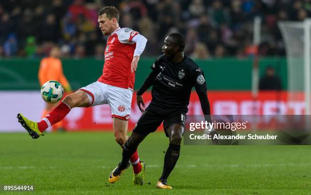 Fabian Frei of Mainz challenges Chadrac Akolo of Stuttgart during the DFB Cup match between 1. FSV Mainz 05 and VfB Stuttgart at Opel Arena on...