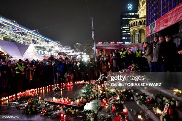 Former German president Joachim Gauck and his partner Daniela Schadt pay their respects at a memorial for the victims of the 2016 deadly truck attack...