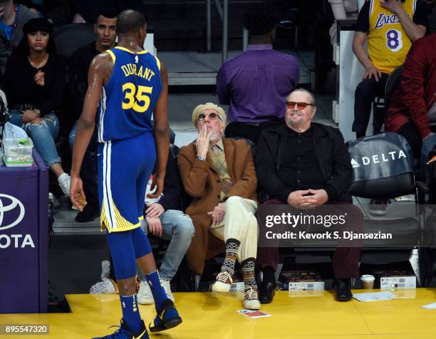 Kevin Durant of the Golden State Warriors speaks with actor Jack Nicholson and record producer Lou Adler during a basketball game between the Golden...