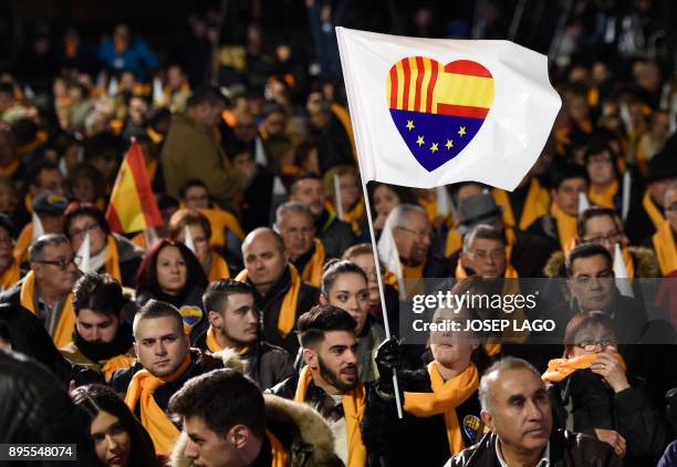 People wait for the start of the center-right party Ciudadanos final campaign meeting for the upcoming Catalan regional election on December 19, 2017...