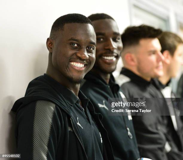 Henri Saivet of Newcastle United and Massadio Haidara smile as they arrive for the annual visit to the RVI Hospital on December 19, 2017 in Newcastle...