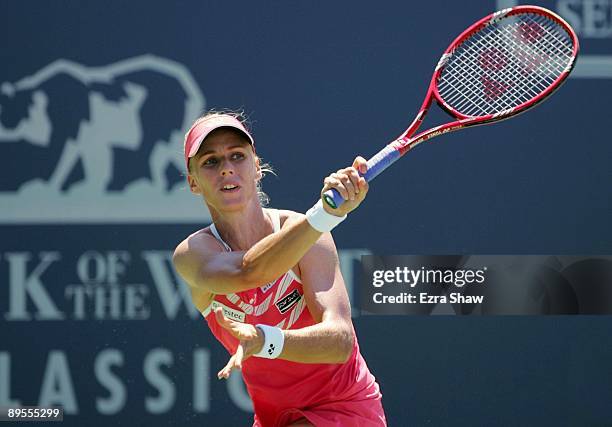 Elena Dementieva of Russia returns a shot to Venus Williams during their semifinal match on Day 6 of the Bank of the West Classic August 1, 2009 in...