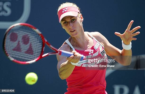 Elena Dementieva of Russia returns a shot to Venus Williams during their semifinal match on Day 6 of the Bank of the West Classic August 1, 2009 in...