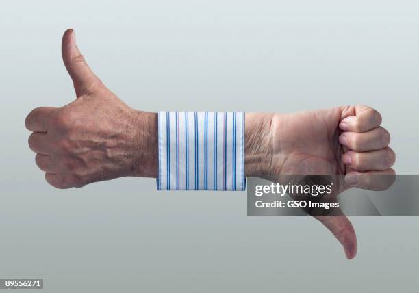 businessmans hands showing thumbs up and down. - long sleeve stock pictures, royalty-free photos & images