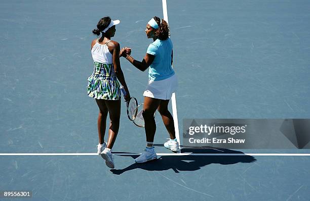 Venus Williams and Serena Williams of the USA shake hands after the won their doubles semi final match against Bethanie Mattek-Sands of the USA and...
