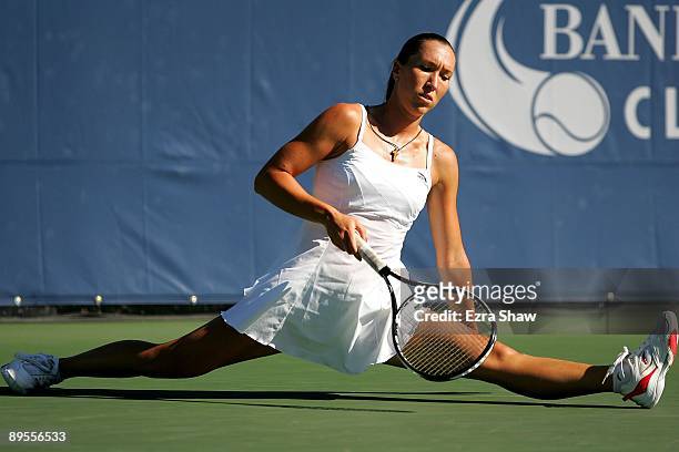 Jelena Jankovic of Serbia does a split after returning a ball to Marion Bartoli of France during their quarterfinal match on Day 5 of the Bank of the...