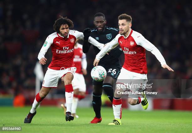 Arthur Masuaku of West Ham United is blocked by Mohamed Elneny and Mathieu Debuchy of Arsenal during the Carabao Cup Quarter-Final match between...