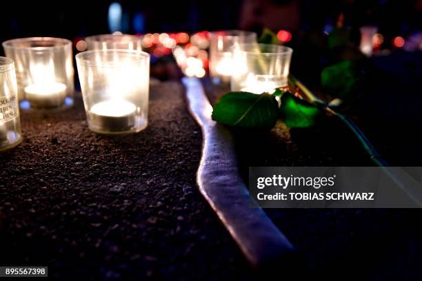 Candles and flowers are left at the memorial shift for the victims of the 2016 deadly truck attack at the Christmas market at Breitscheidplatz in...