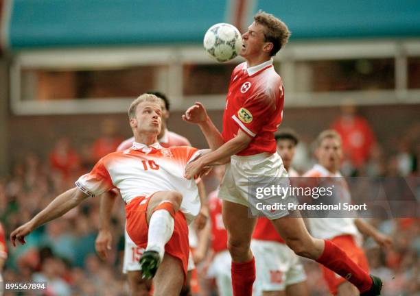 Dennis Bergkamp of the Netherlands and Stéphane Henchoz of Switzerland battle for the ball during the UEFA Euro 96 group match between the...