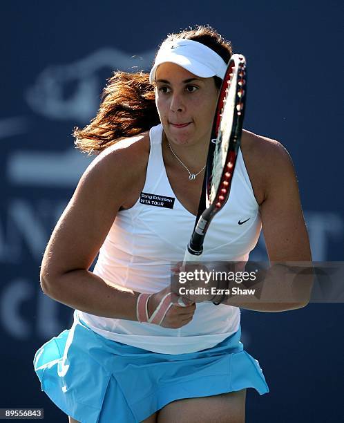 Marion Bartoli of France runs to get the ball during her match against Melanie Oudin of the USA on Day 4 of the Bank of the West Classic at Stanford...