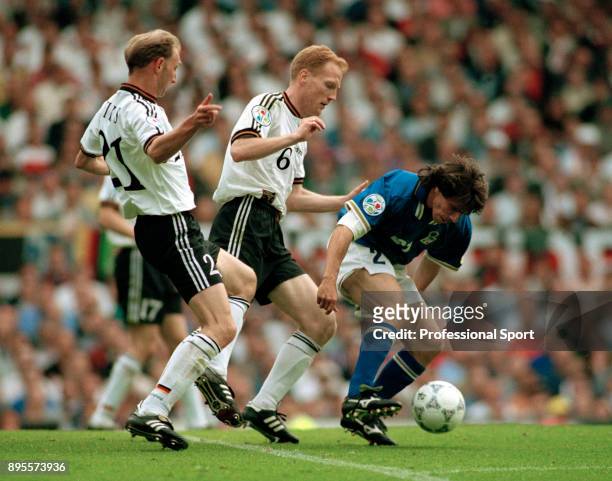 Dieter Eilts and Matthias Sammer of Germany put pressure on Gianfranco Zola of Italy during a UEFA Euro 96 group match at Old Trafford on June 19,...