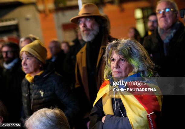 Woman wrapped in a Catalan pro-independence 'Estelada' flag attends 'Junts per Catalonia' - JUNTSXCAT final campaign meeting for the upcoming Catalan...