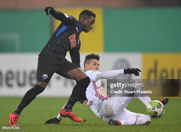 Christopher Antwi-Adjej of Paderborn is challenged by Alfredo Morales of Ingolstadt during the DFB Cup match between SC Paderborn and FC Ingolstadt...