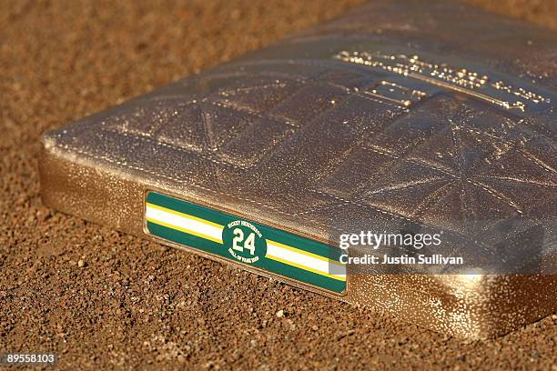 Golden base with Hall of Fame baseball player Rickey Henderson's number 24 is seen on the field before the start of a ceremony to retire his number...