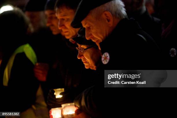 Mourners hold candles as they commemorate the first anniversary of the 2016 Christmas market terror attack at the attack site on December 19, 2017 in...