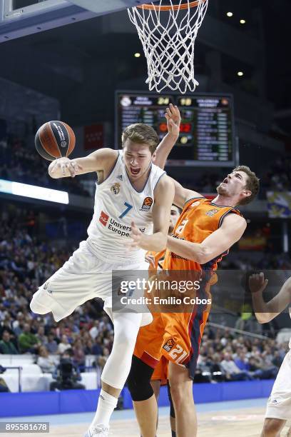 Luka Doncic, #7 of Real Madrid competes with Tibor Pleiss, #21 of Valencia Basket during the 2017/2018 Turkish Airlines EuroLeague Regular Season...