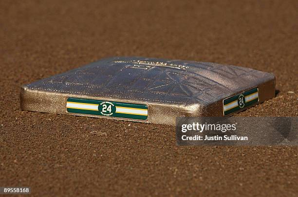 Golden base with Hall of Fame baseball player Rickey Henderson's number 24 is seen on the field before the start of a ceremony to retire his number...