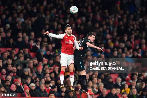 Arsenal's German-born Bosnian defender Sead Kolasinac jumps against West Ham United's Irish defender Declan Rice during the English League Cup...