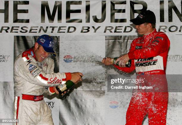 Ryan Briscoe, driver of the Team Penske Dallara Honda celebrates by spraying champagne over second placed Ed Carpenter after winning the IRL IndyCar...