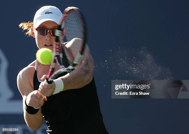 Samantha Stosur of Australia returns a shot to Marian Bartoli of France during their semifinal match on Day 6 of the Bank of the West Classic August...