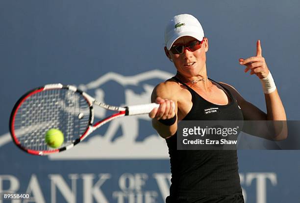 Samantha Stosur of Australia returns a shot to Marian Bartoli of France during their semifinal match on Day 6 of the Bank of the West Classic August...