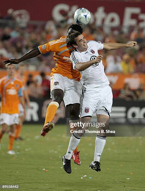 Ade Akinbiyi of the Houston Dynamo heads the ball against Chris Pontius of D.C. United at Robertson Stadium on August 1, 2009 in Houston, Texas.