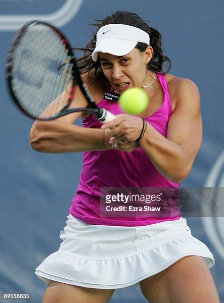 Marion Bartoli of France returns a shot to Samantha Stosur of Australia during their semifinal match on Day 6 of the Bank of the West Classic August...