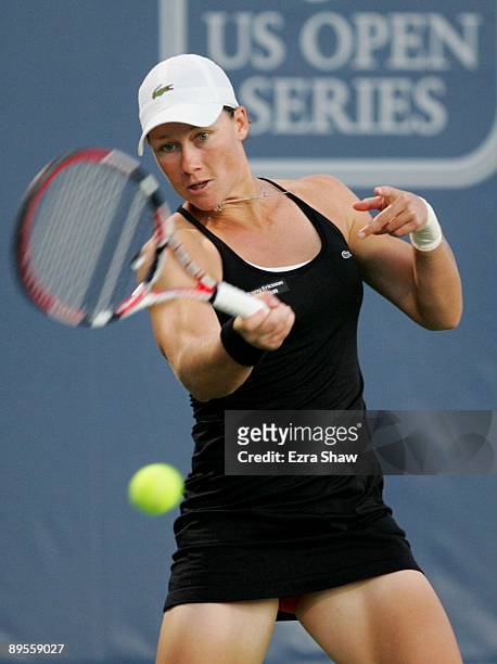 Samantha Stosur of Australia return a shot to Marian Bartoli of France during their semifinal match on Day 6 of the Bank of the West Classic August...