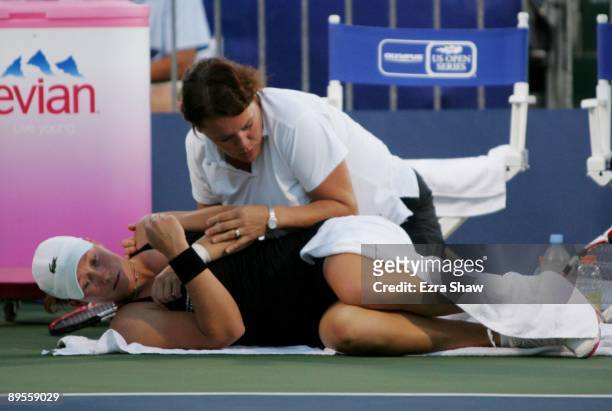 Samantha Stosur of Australia is tended to by a trainer during the semifinal match against Marian Bartoli of France on Day 6 of the Bank of the West...