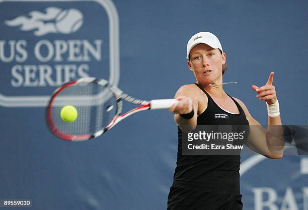 Samantha Stosur of Australia returns a shot to Marian Bartoli of France during their semifinal match on Day 6 of the Bank of the West Classic August...