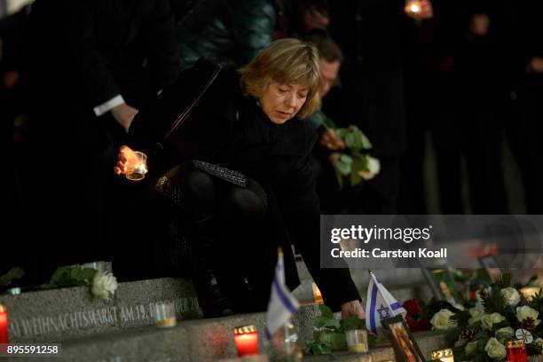 Daniela Schadt leaves a candle during a ceremony to commemorate the first anniversary of the 2016 Christmas market terror attack at the site of the...