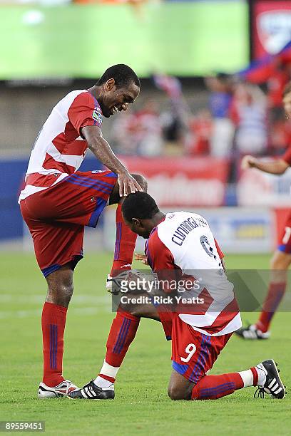 Jeff Cunningham gives Atiba Harris of the FC Dallas a congratulatory shoe shine following a goal assist against the Kansas City Wizards at Pizza Hut...