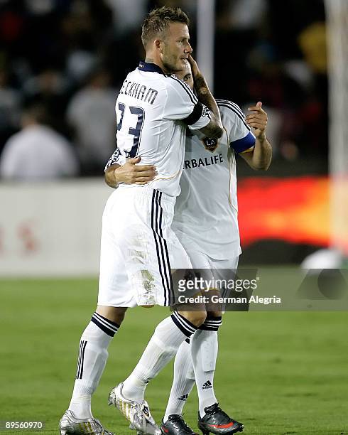 David Beckham and Landon Donovan of the Los Angeles Galaxy celebrate goal scored against FC Barcelona during the first half of the friendly soccer...