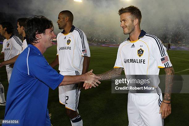 David Beckham of the Los Angeles Galaxy and Lionel Messi of FC Barcelona shake hands prior to their International Friendly match at The Rose Bowl on...