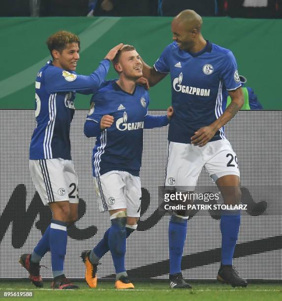 Schalke's French midfielder Amine Harit, Schalke's German midfielder Max Meyer and Schalke's Brazilian defender Naldo celebrate after scoring during...