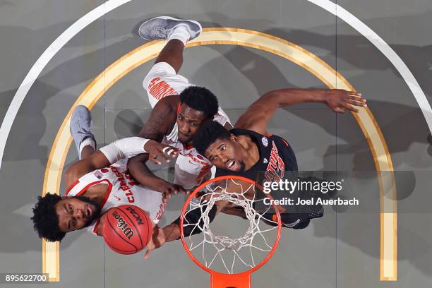 Kevarrius Hayes of the Florida Gators battles for a rebound against Gabe DeVoe and Elijah Thomas of the Clemson Tigers during the MetroPCS Orange...