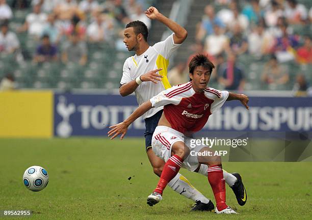 English Premier League team Tottenham Hotspur's John Bostock duels for the ball with Hong Kong club South China's Lee Wai Lun during their Panasonic...