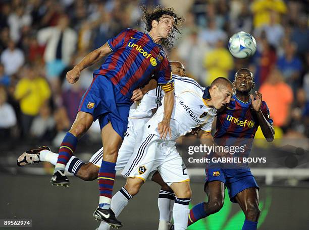 Barcelona defenders Carles Pujol and Eric Abidal fight for the ball with Los Angeles Galaxy striker Alan Gordon during the exhibition game Los...